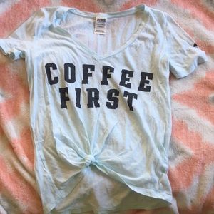 Pink Shirt says "Coffee First"